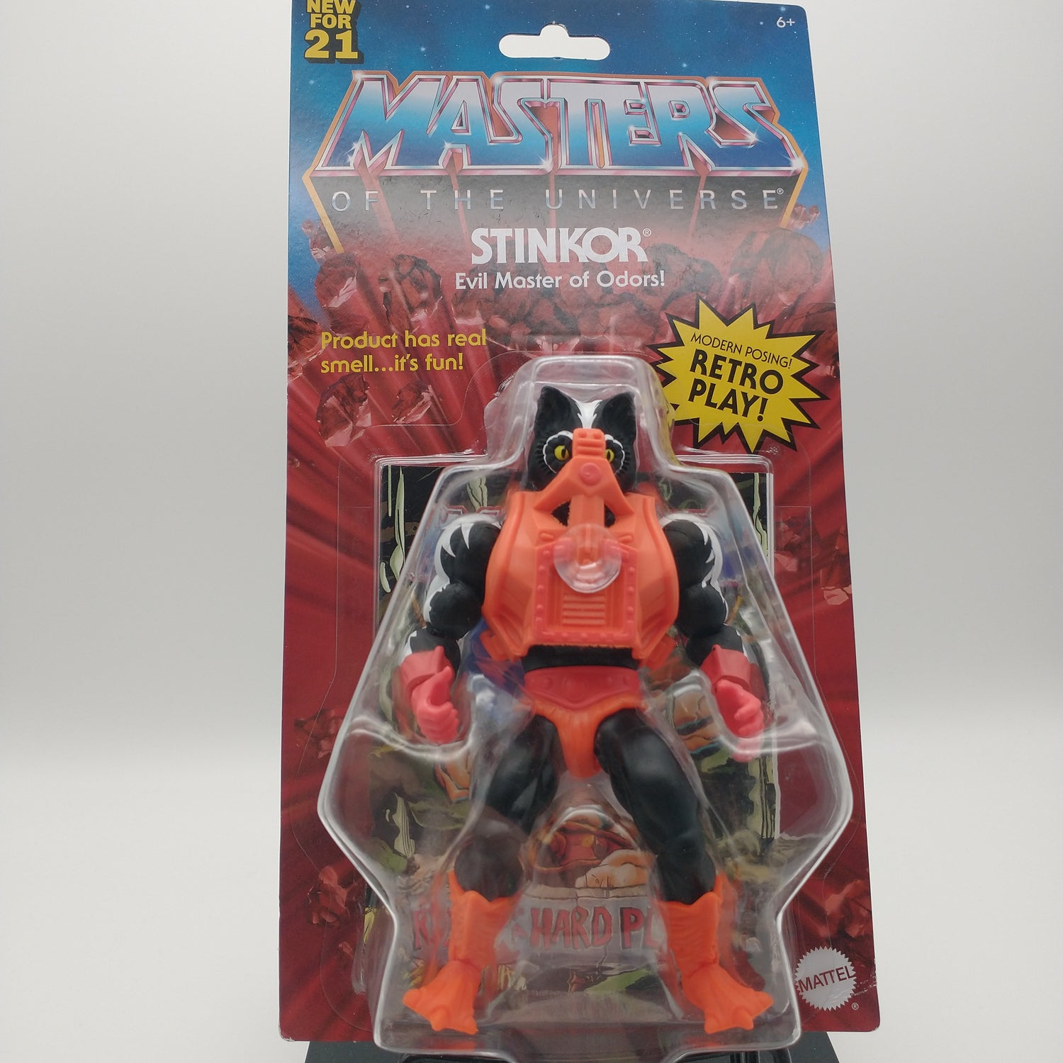 The front of the box and bubble. The bubble is sealed, the action figure inside is a humanoid with the fur and stripes of a skunk. He's wearing orange boots, red gloves, and a chestpiece that covers the bottom part of this face. There's text on the card that reads "Product has real smell...it's fun!"