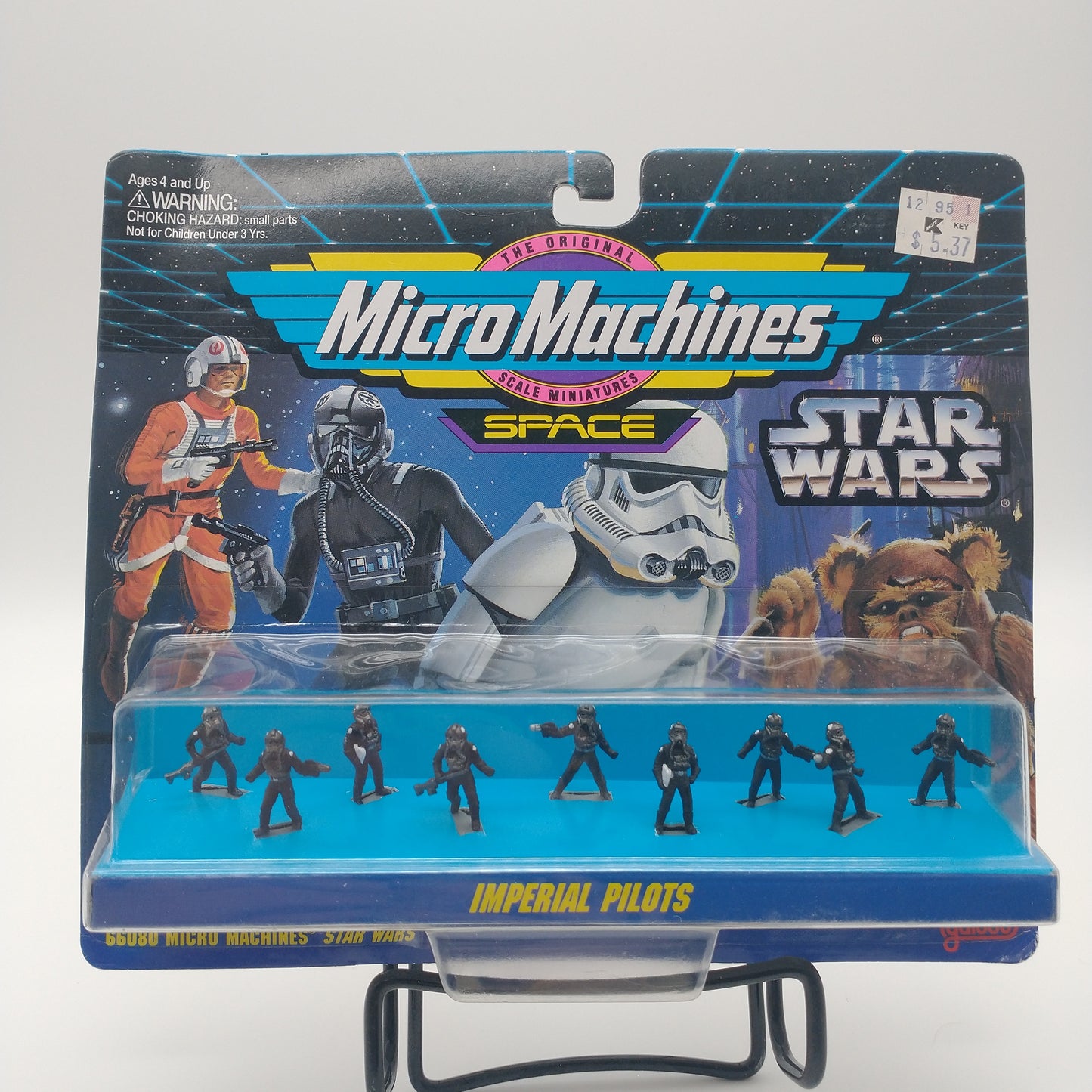 The front of the box and bubble. The bubble is sealed, the action figures inside are miniatures of imperial pilots wearing black flight suits and black helmets in various positions