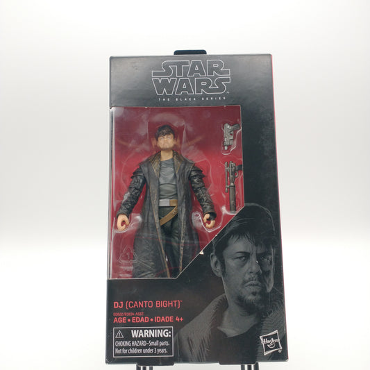 The front of the box and bubble. The bubble is sealed and the action figure inside is wearing a long trenchcoat and hat. There are two guns to his left. 