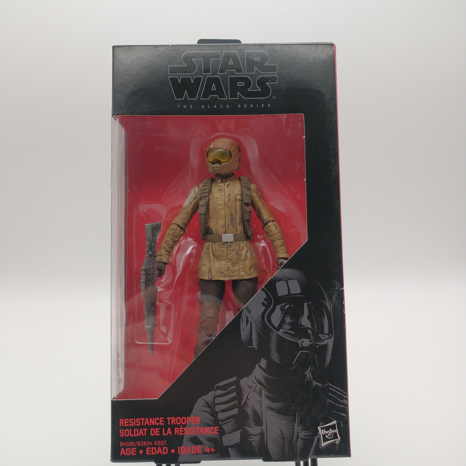 The front of the box and bubble. The bubble is sealed and the action figure inside is wearing a tan overcoat, a harness, a helmet, and holding a gun.