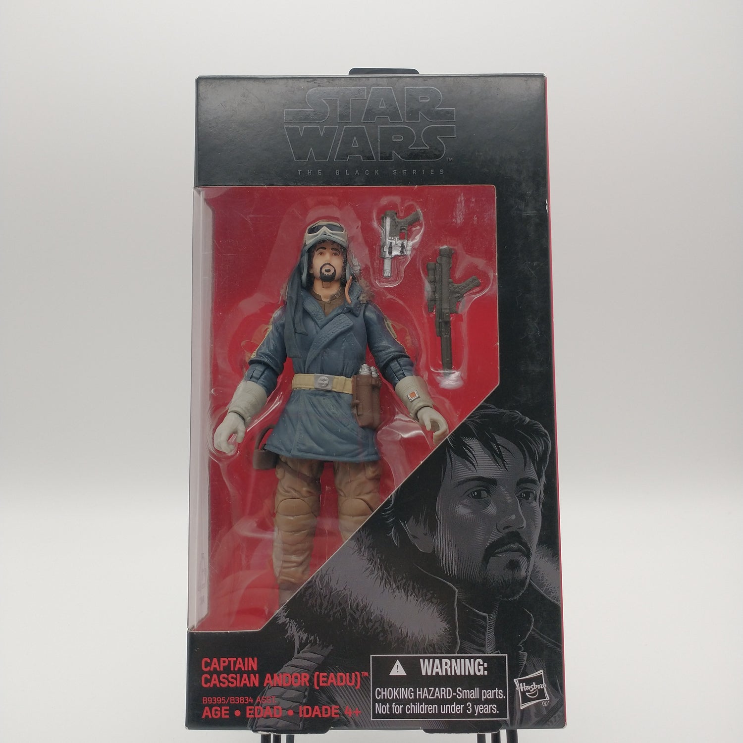 The front of the box and bubble. The action figure inside is wearing a blue coat, a hat with goggles, brown pants, and white golves. There are two guns next to him in the bubble.