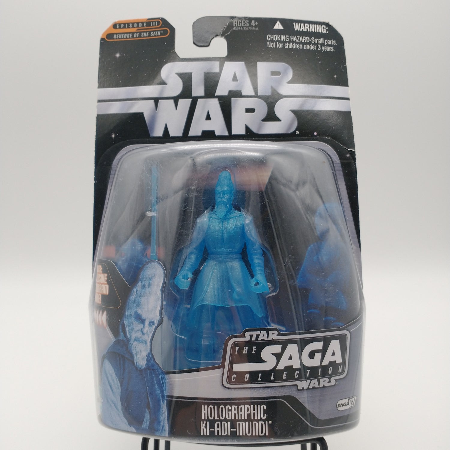 The front of the card and bubble are intact. The action figure inside is translucent and blue.