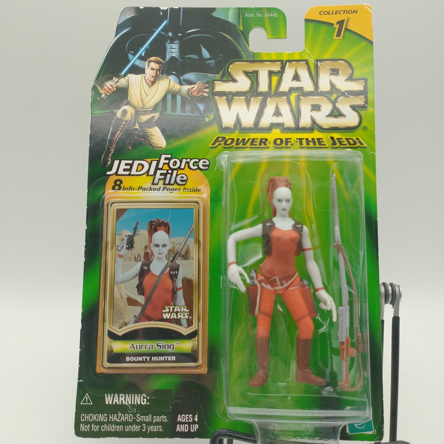 The front of the bubble and card. The action figure is a completely white figure wearing an orange jumpsuit and orange leggings. 