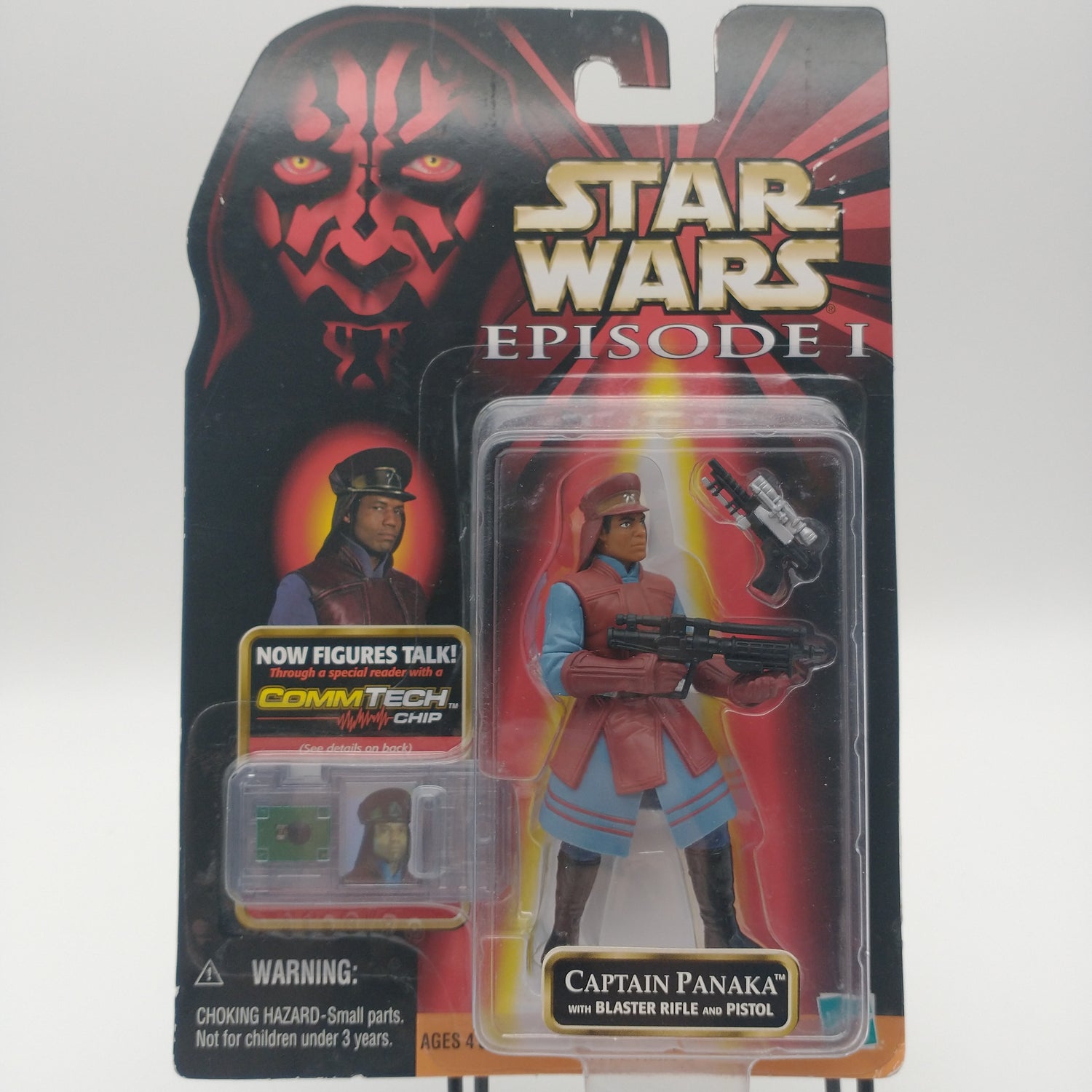 The front of the card and bubble. The action figure is sealed inside the bubble, and he has two guns, he's wearing a reddish brown hat