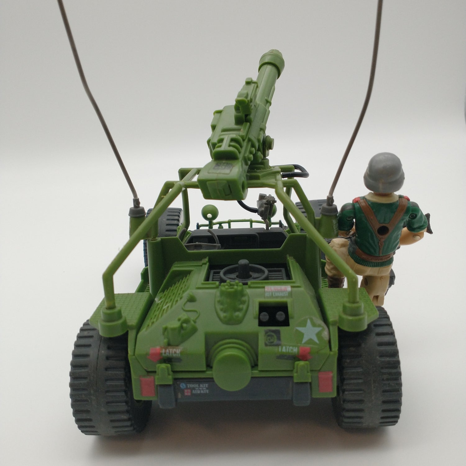The back of the figure and vehicle.