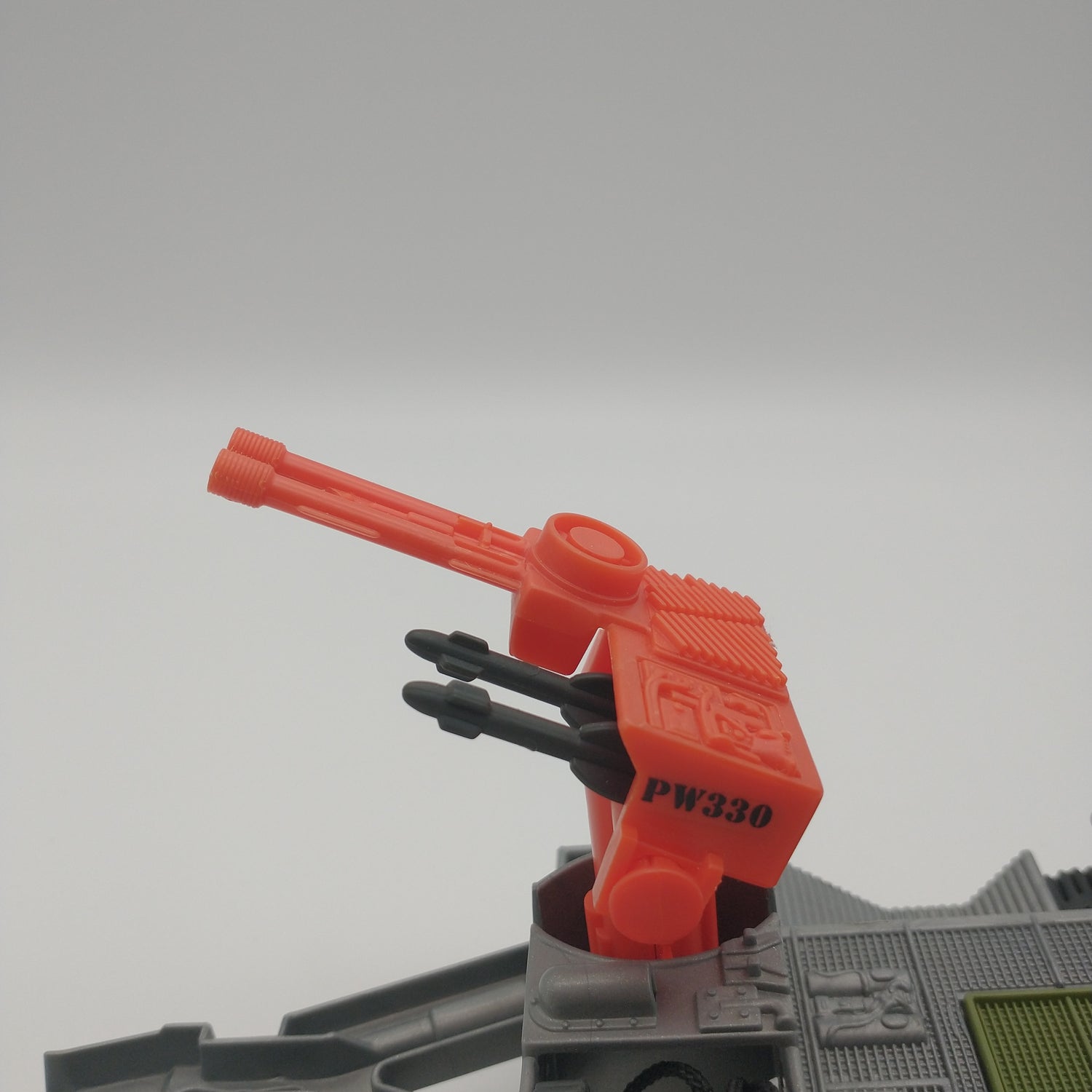 An orange missile launcher mounted on top of the vehicle