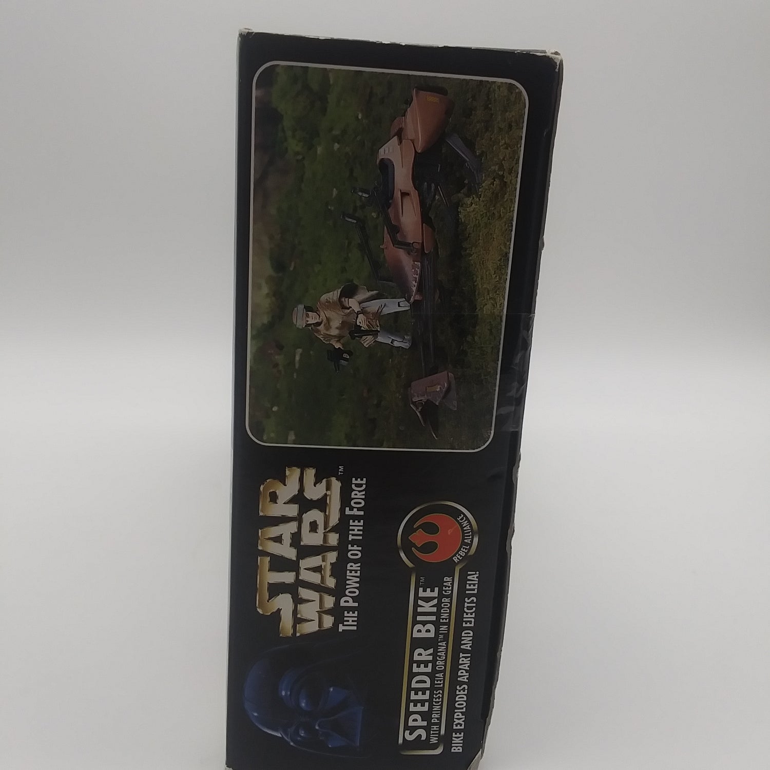 The left side of the box with a picture of the figure and speeder bike