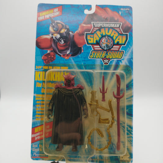 A picture of the front card and bubble. The bubble is slightly yellowed. It contains the action figure of Klokhan wearing a red cowl and black cloack, his weapons are next to him in the bubble. They include a red dagger, a red spear, a gold whip, and a gold gun.